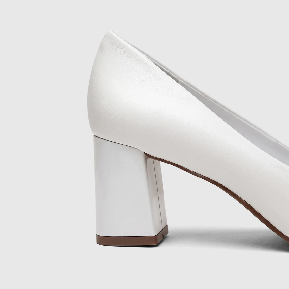 Side view of a white Capelli Rossi leather ladies block heel court shoe, showcasing its contemporary design and sturdy heel.