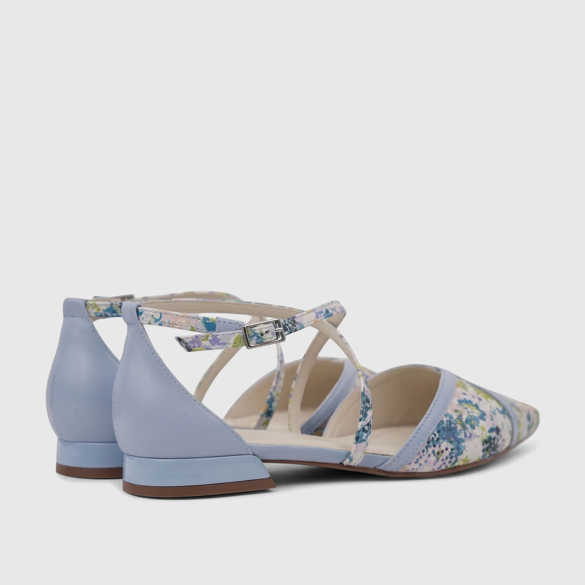 Two blue Capelli Rossi Leather Ladies Pumps, featuring a floral pattern and elegant ankle straps, from a side-back view.