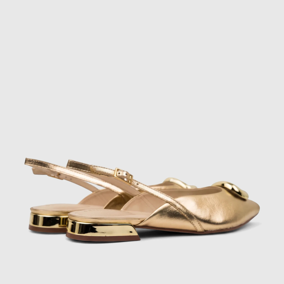 Capelli Rossi light gold leather ladies slingback pumps, featuring a metallic finish and low block heels, viewed from a side