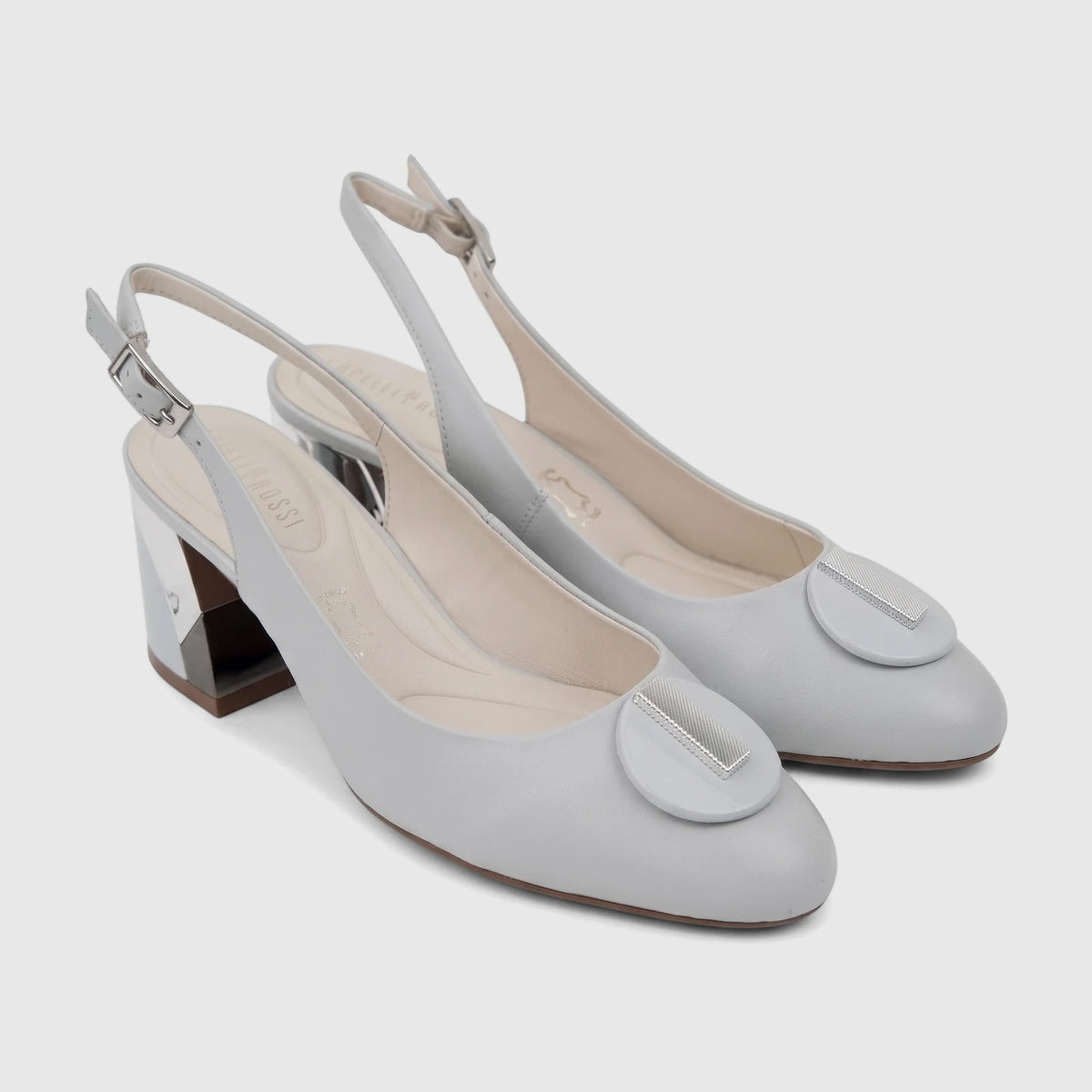 Pair of Capelli Rossi powder blue leather slingback block heel court shoes, with reflective heels and silver-toned hardware.