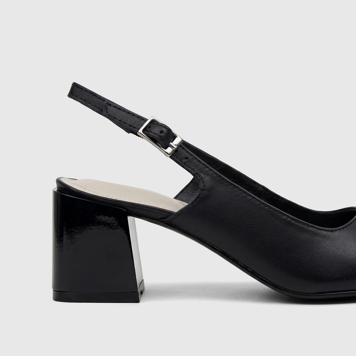 Black Capelli Rossi leather slingback block heel court shoe, featuring a glossy block heel and a silver buckle on the strap,