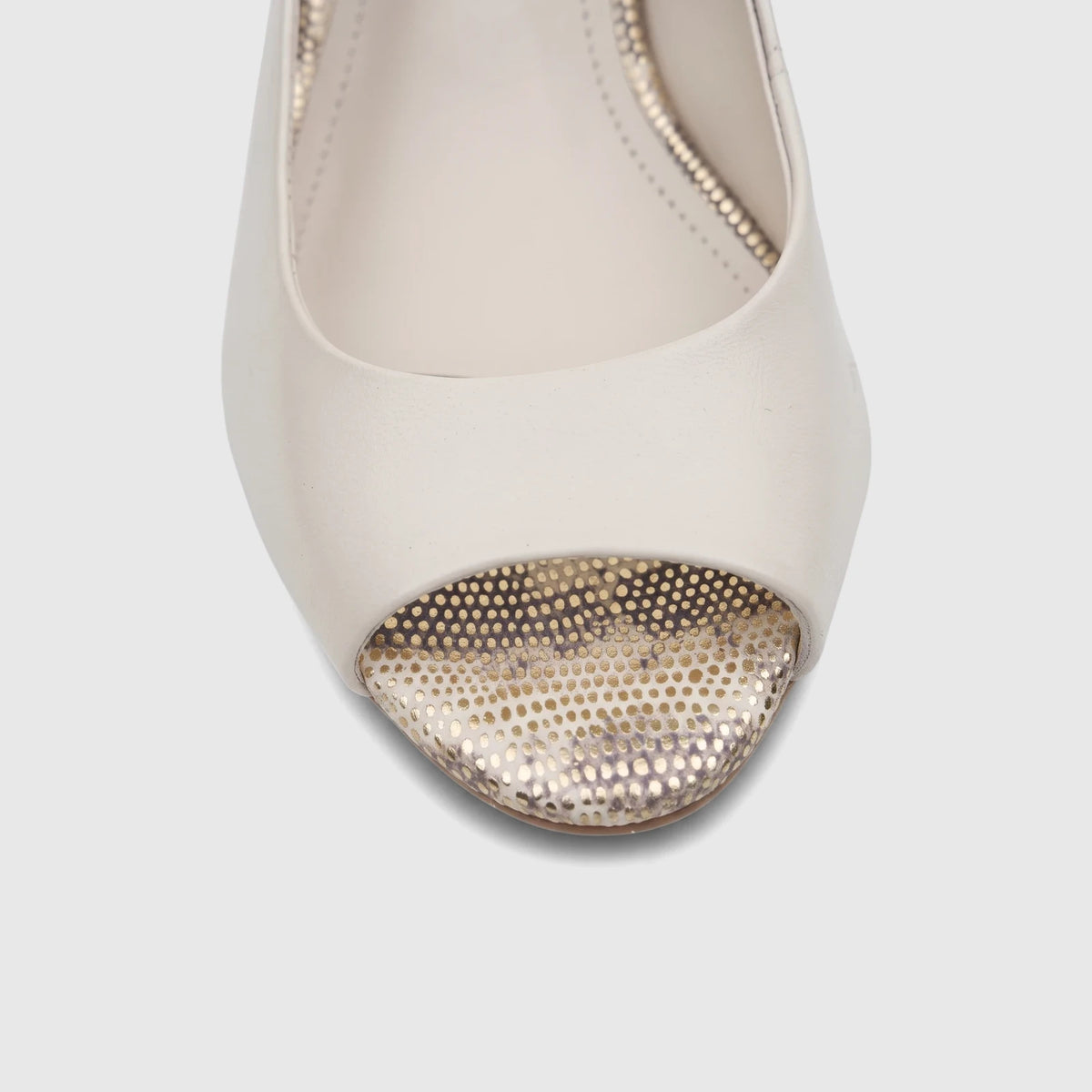 Close-up view of a Capelli Rossi ladies' slingback block heel peep toe shoe in bone leather with a distinctive gold