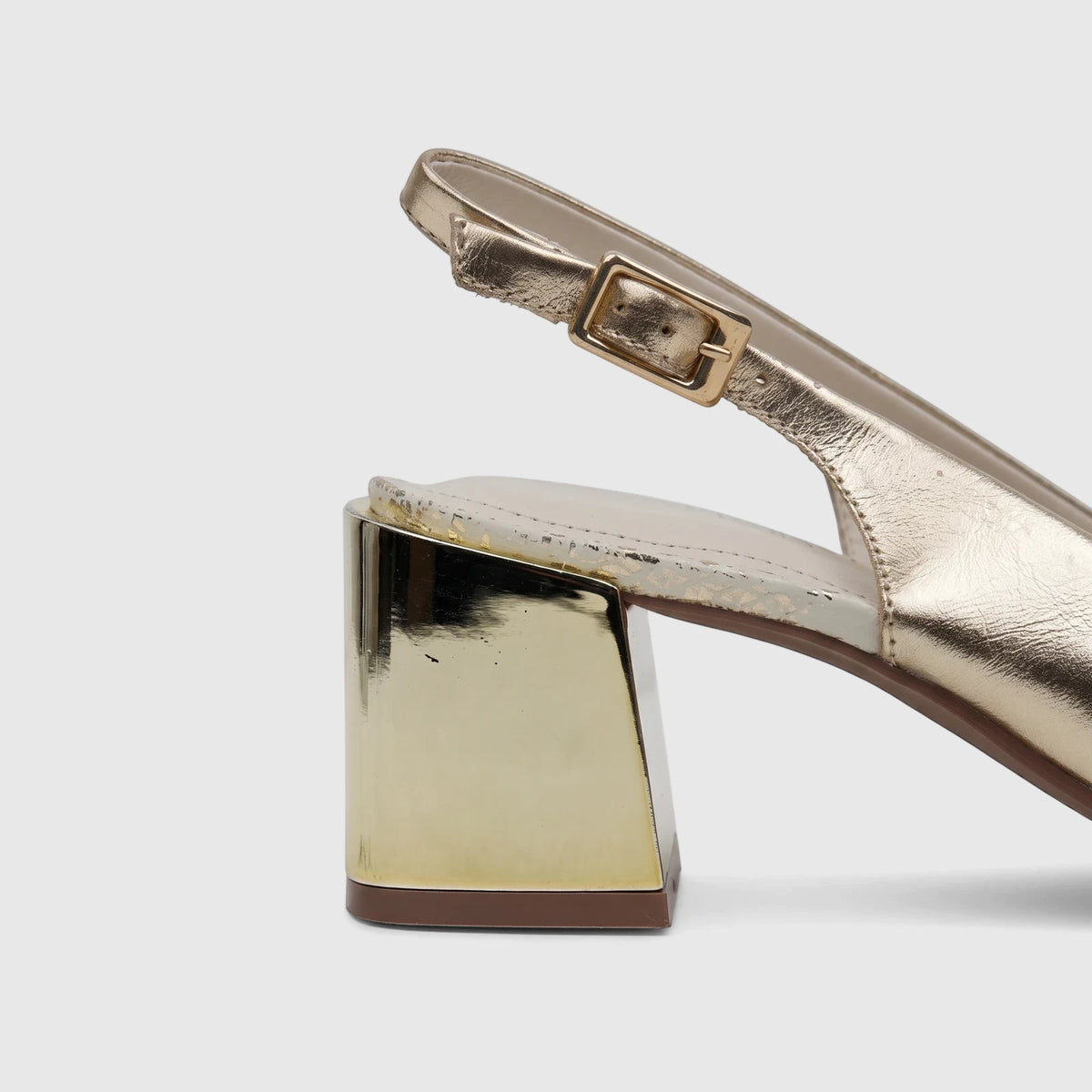 Capelli Rossi light gold leather slingback court shoe with a block heel, visible from the side.