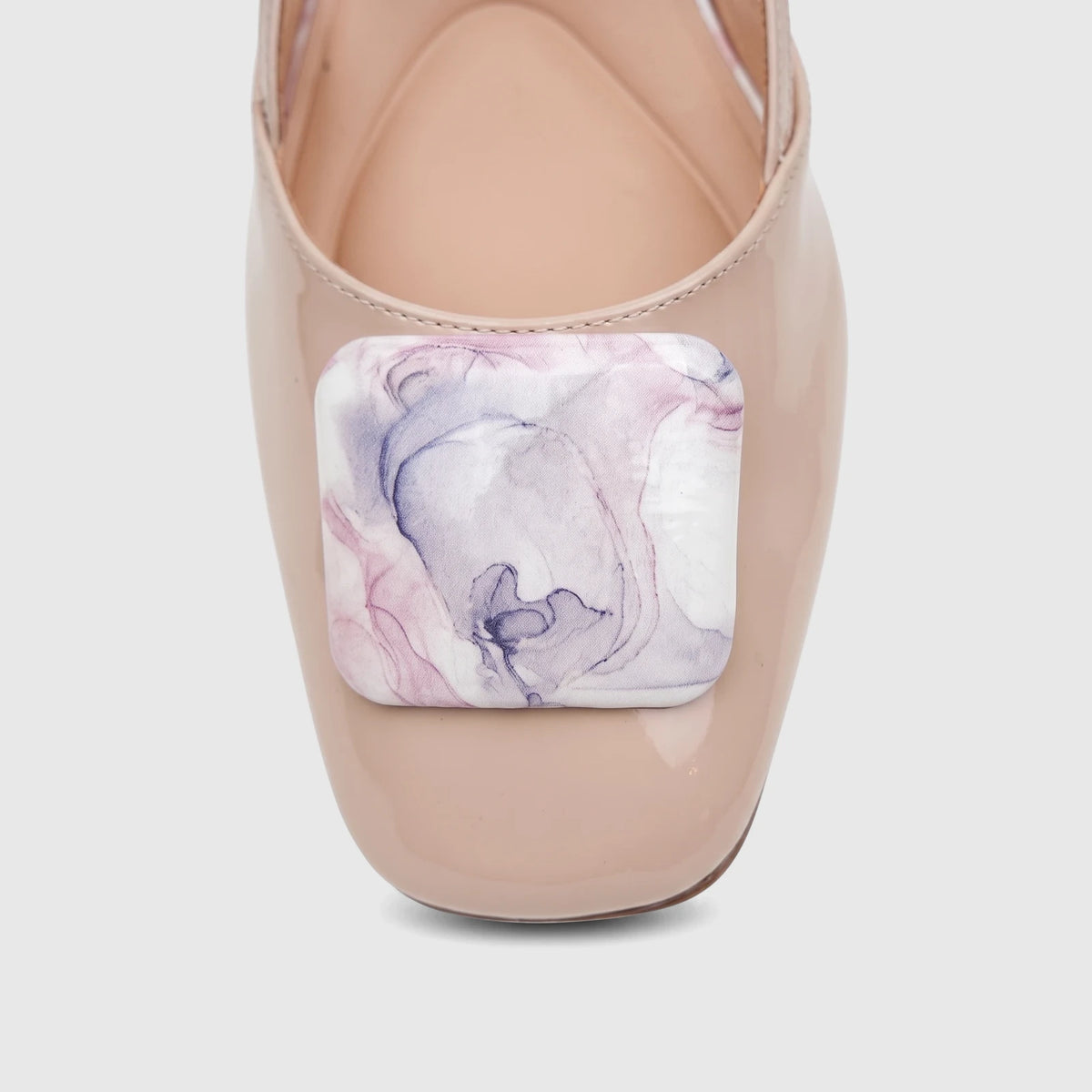 Nude pink patent leather Capelli Rossi ladies slingback court shoe with a low block heel and marble buckle.