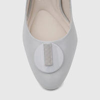 Close-up of a Capelli Rossi powder blue leather slingback court shoe, featuring a circular toe embellishment with a striped