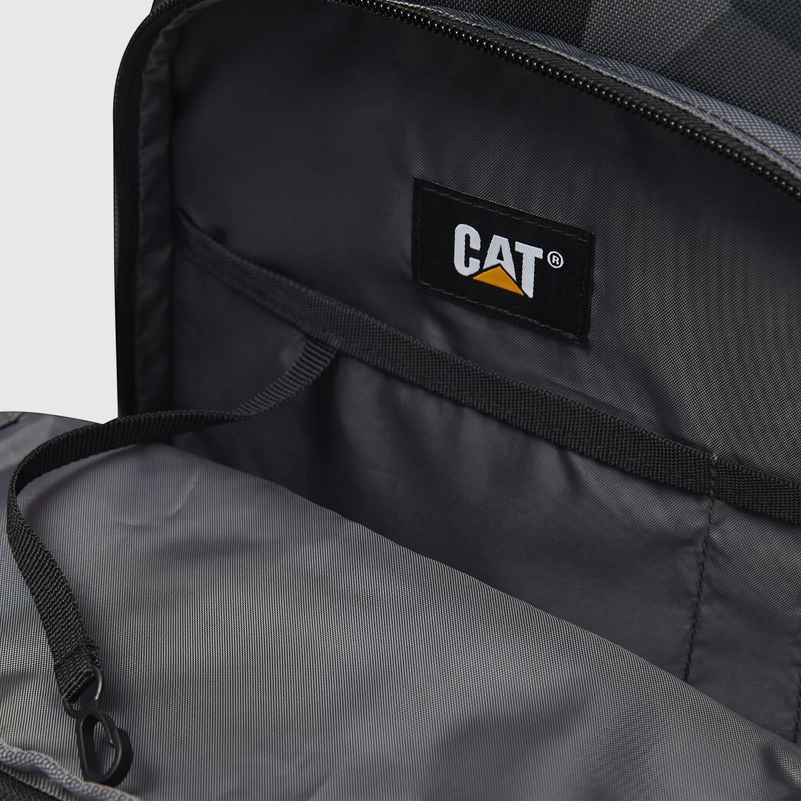Cat Bernard backpack interior in dark grey, showcasing the main compartment, internal pockets, and a black strap with clip,
