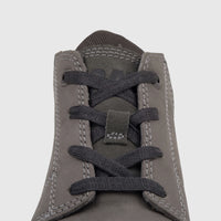 Close-up of a gray Cat Men's Threshold Chukka boot, featuring intricate dark lacing and visible white stitching.