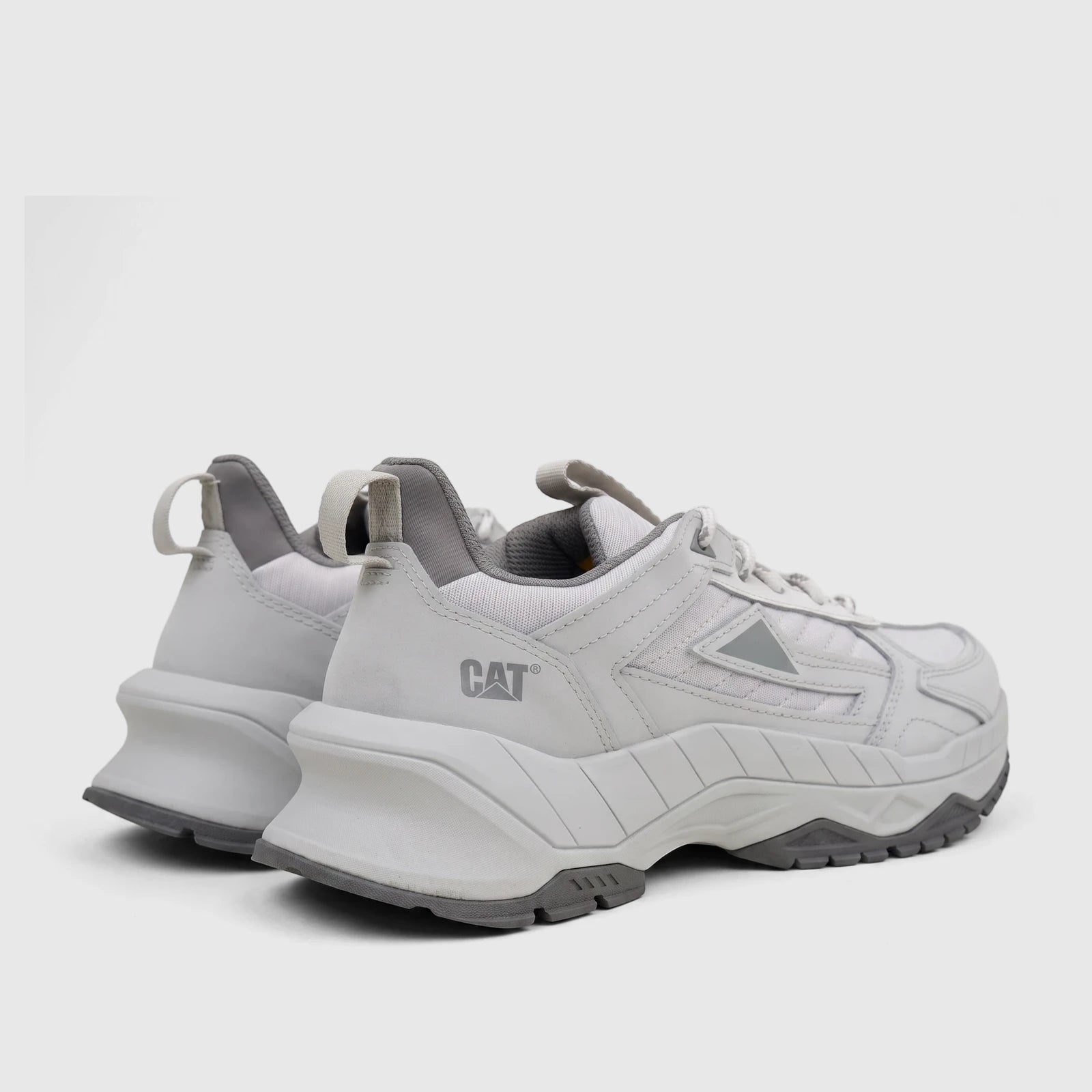 A pair of light grey Cat Men's Amperage P726915 sneakers with chunky soles, shown from a rear-three-quarter view on a white