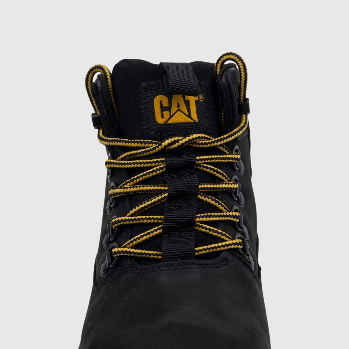 Close-up of a black Cat Men's Colorado Expedition hiking boot with yellow and black laces and CAT logo on the tongue.