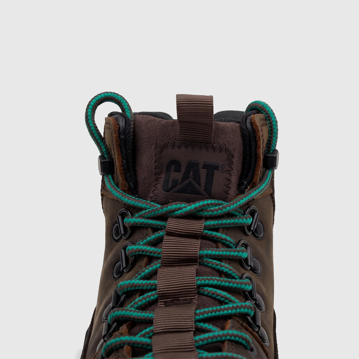 Close-up of a Cat Men's Colorado Expedition Hiker boot in dark chocolate brown with striking teal laces, showing the CAT