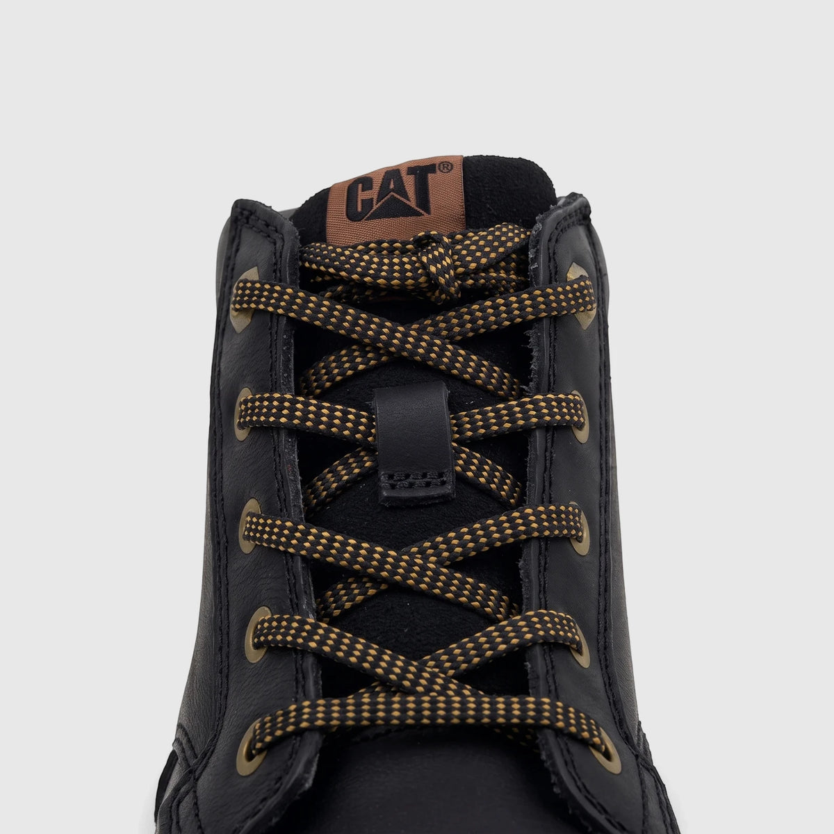 Close-up of a black Cat Men's Estimate Chukka boot with gold and black speckled laces and a CAT logo patch.
