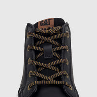 Close-up of a black Cat Men's Estimate Chukka boot with gold and black speckled laces and a CAT logo patch.