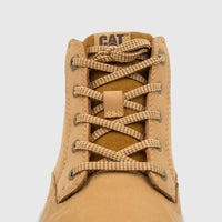 Close-up of a single tan Cat Men's Estimate Chukka boot, showcasing its honey-colored suede and detailed criss-cross lacing.