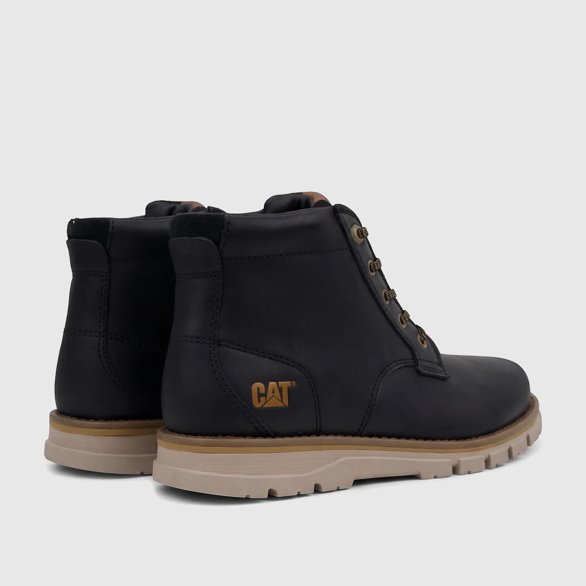 Black Cat Men's Estimate Chukka boots, made of leather with tan soles, shown from a rear-side view.