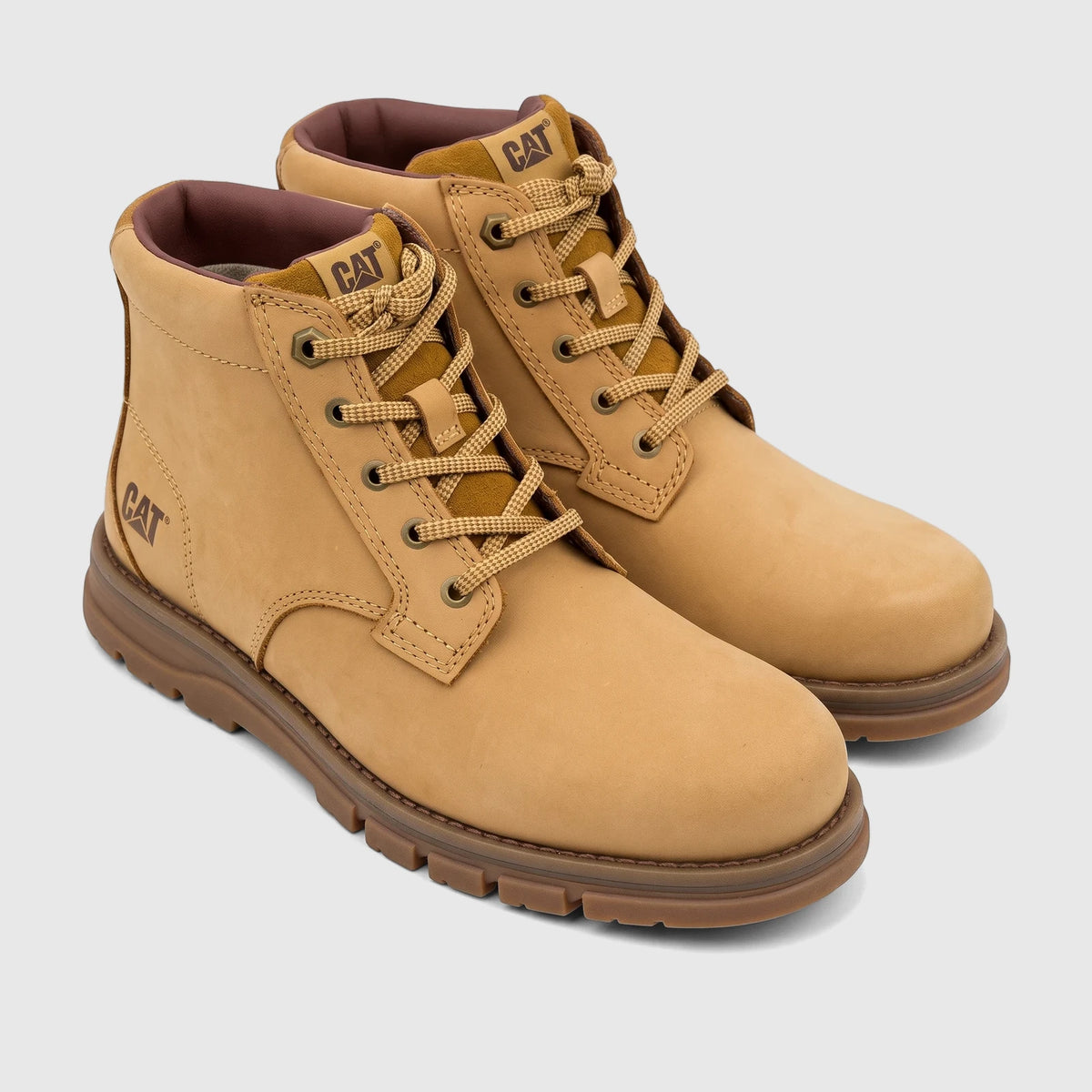 Pair of Men's Cat Estimate Chukka boots in honey brown, featuring a durable design with laces and a sturdy sole.