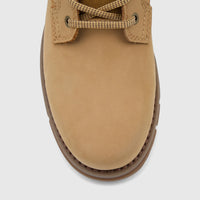 Close-up top view of a Cat Men's Estimate Chukka boot in honey nubuck, featuring detailed lacing and a sturdy sole.