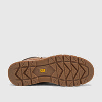 Bottom view of a brown Cat Men's Estimate Chukka boot, showing its sturdy lug sole with a yellow CAT logo.