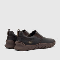 Cat Men's Flexion slip-on shoes in dark brown leather with textured soles, displayed from a rear-quarter view.
