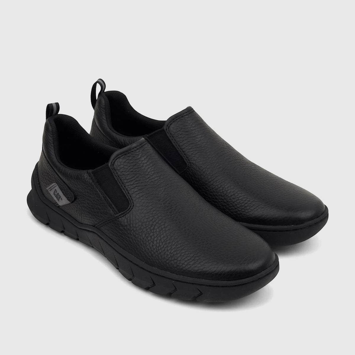 A pair of black textured leather Cat Men's Flexion slip-on shoes (P726867) with elastic goring and heel pull tabs.