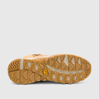 Bottom view of a single Cat Men's Grapple Leather Mid boot in honey color, featuring its rugged brown and tan lug sole with