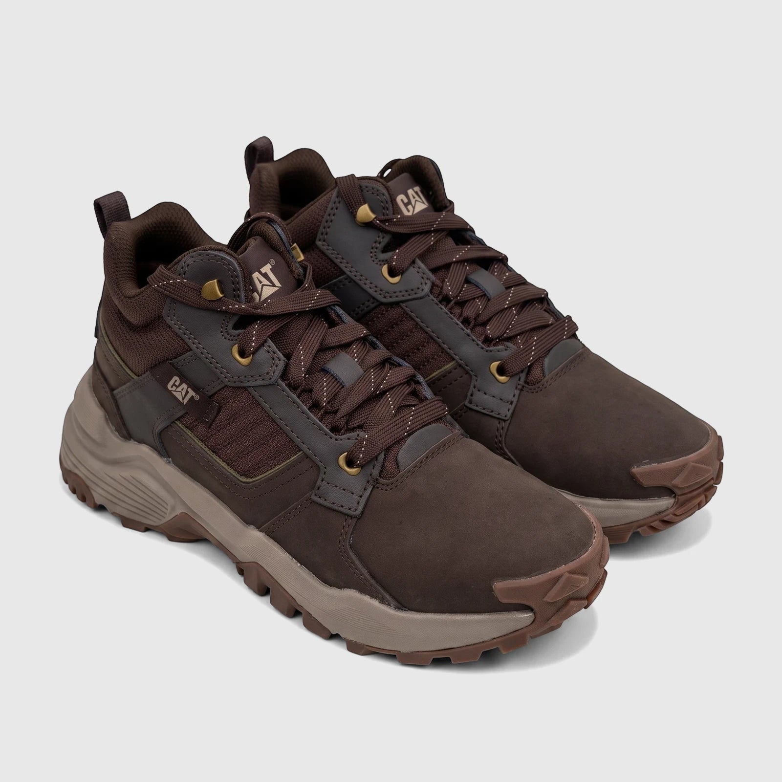 Pair of brown Cat Men's Grapple Leather Mid P727011 Coffee Bean CT395 shoes, featuring durable leather, mesh panels, and