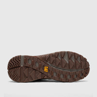 Bottom view of a brown Cat Men's Grapple Leather Mid shoe, showcasing its rugged rubber sole with deep traction patterns and