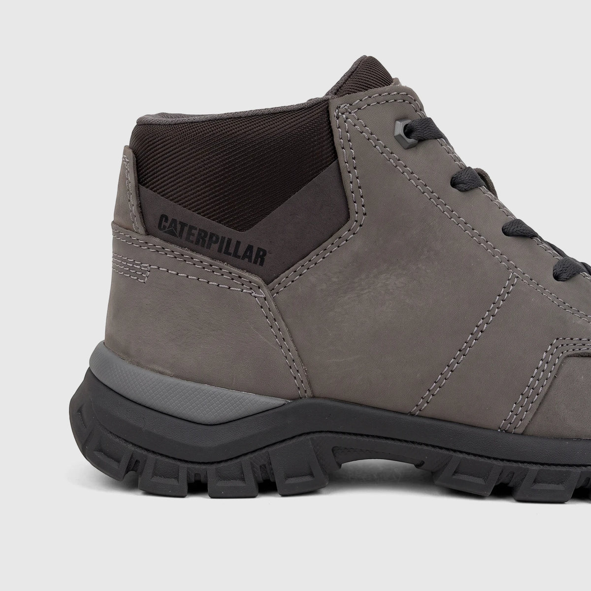 Close-up side view of a gray Cat Men's Threshold Chukka P726890 work boot with a Caterpillar logo on the ankle, black sole,