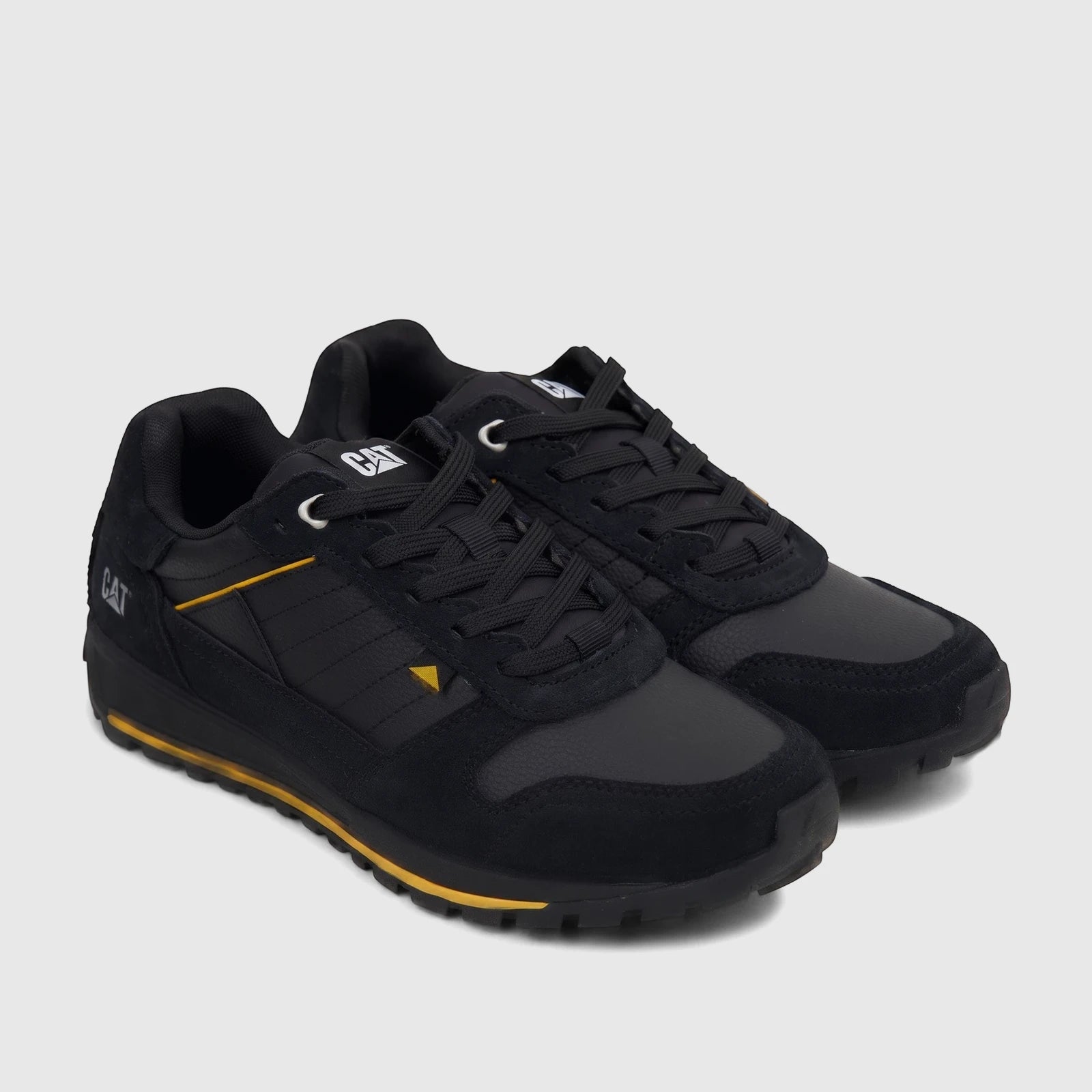 Cat Men's Trigen P726923 Black sneakers with yellow accents and durable construction on a clean white background.