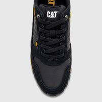 Close-up top view of a black Cat Men's Trigen P726923 CT401 sneaker with yellow accents and black laces.