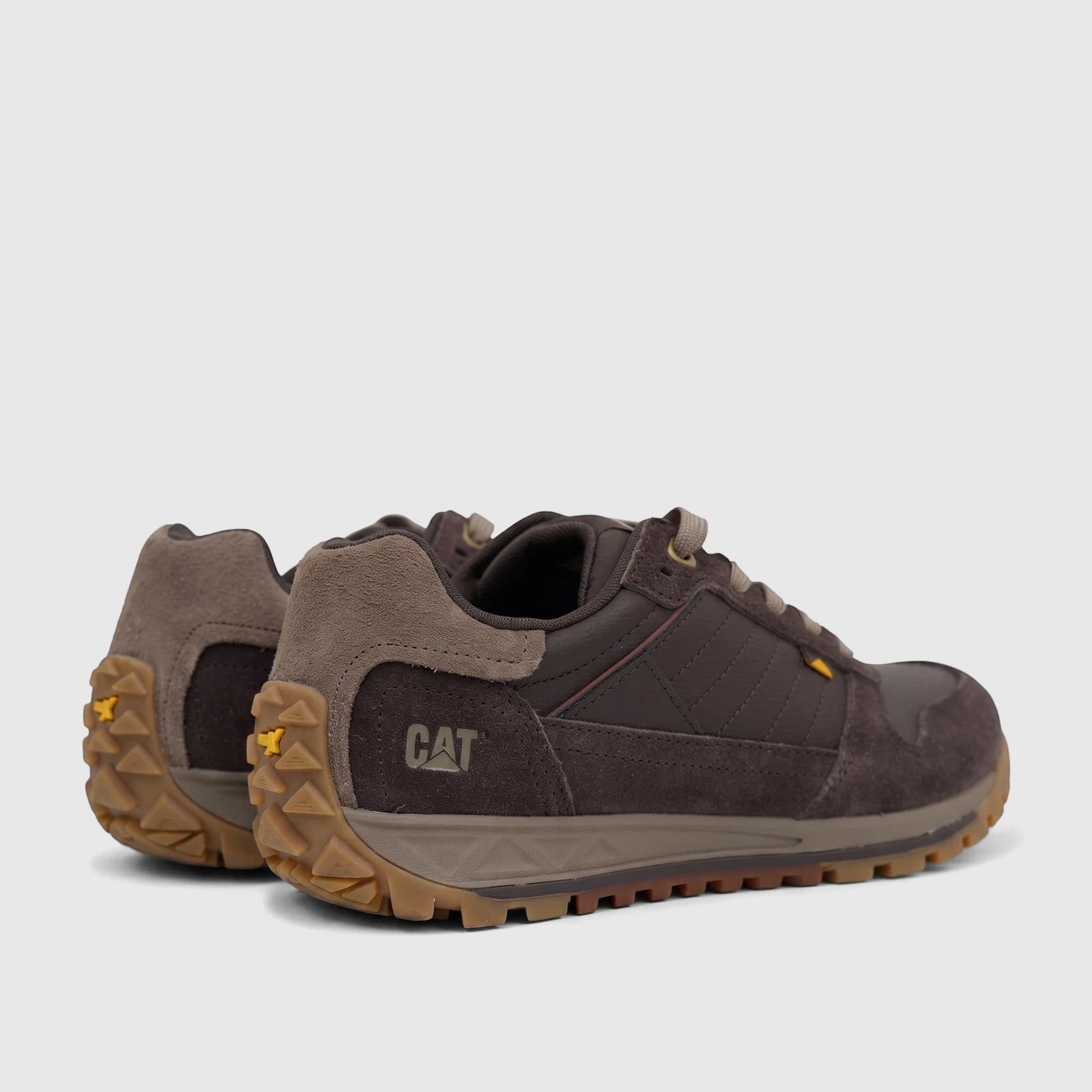 Pair of Cat Men's Trigen P726924 Coffee Bean CT402 sneakers, featuring brown suede and synthetic uppers with a rugged tan