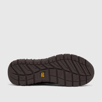 Underside view of a dark brown Cat Men's Versage Slip On P727013 shoe, showcasing its rugged sole and yellow CAT logo.