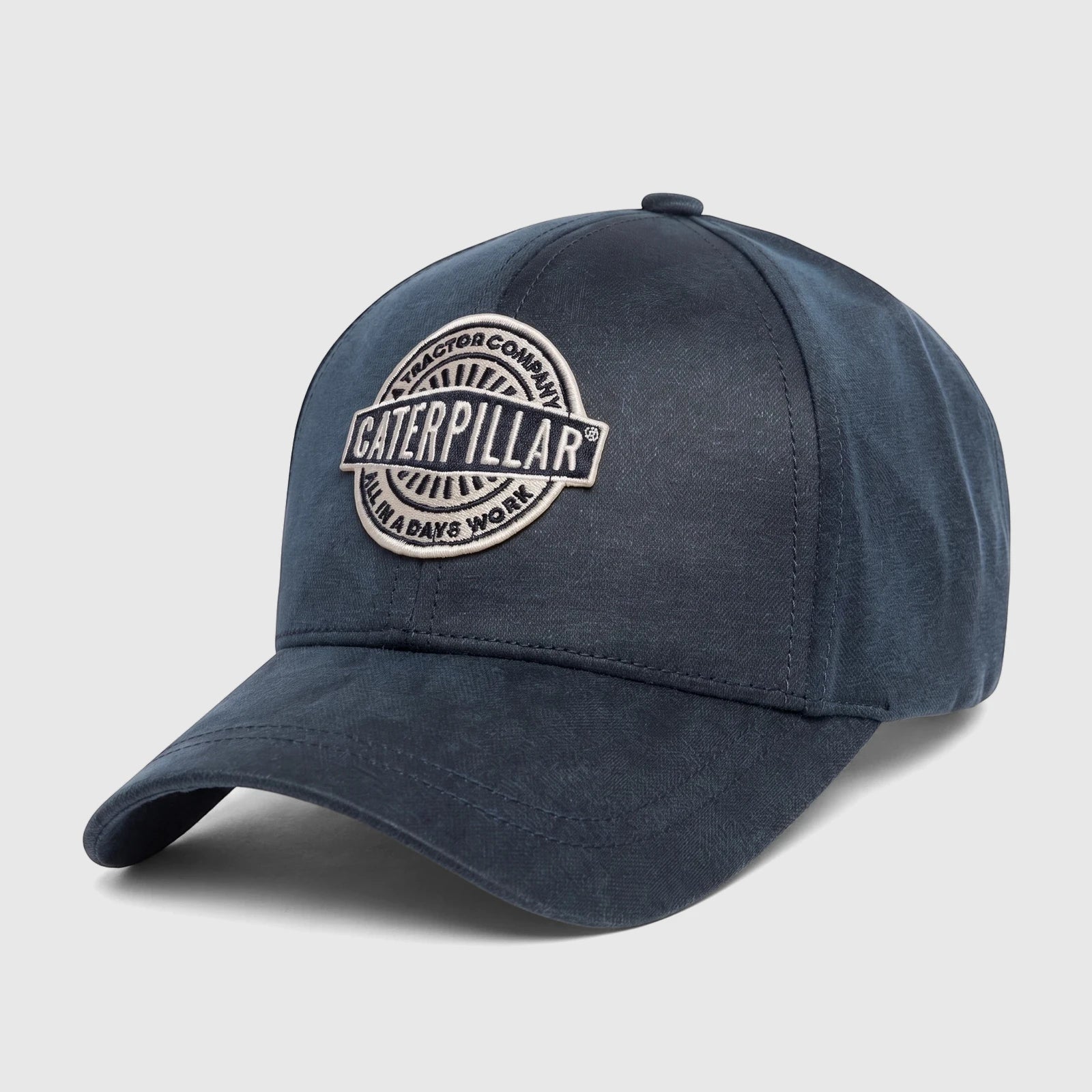 Inkwell navy blue Cat Tractor Company baseball cap with an embroidered 'Caterpillar All In A Day's Work' logo.