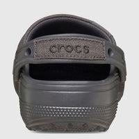 Back view of a Classic Crafted Clog in Black Sand, featuring a textured sole and a fabric heel strap with Crocs branding.