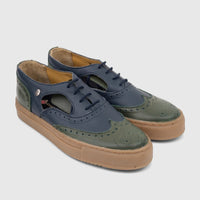 A pair of Crockett and Jones Men's Lace Up Brogue Alonzo shoes in navy and olive green leather, featuring intricate brogue
