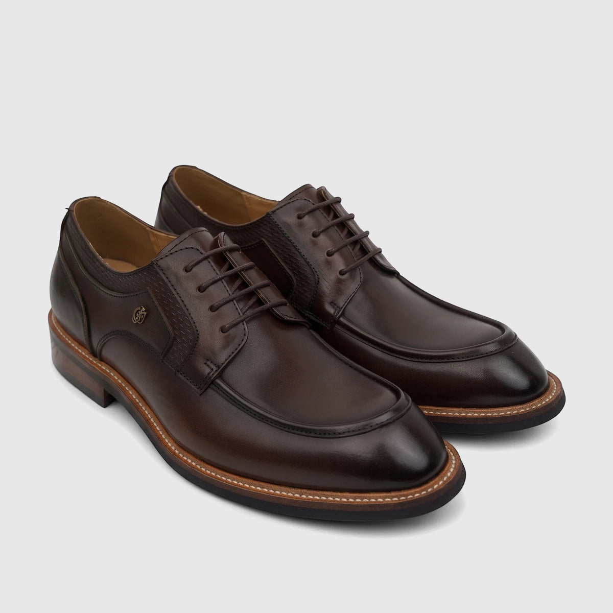 Pair of men's Crockett And Jones Guilio coffee brown leather lace-up derby shoes with decorative stitching.