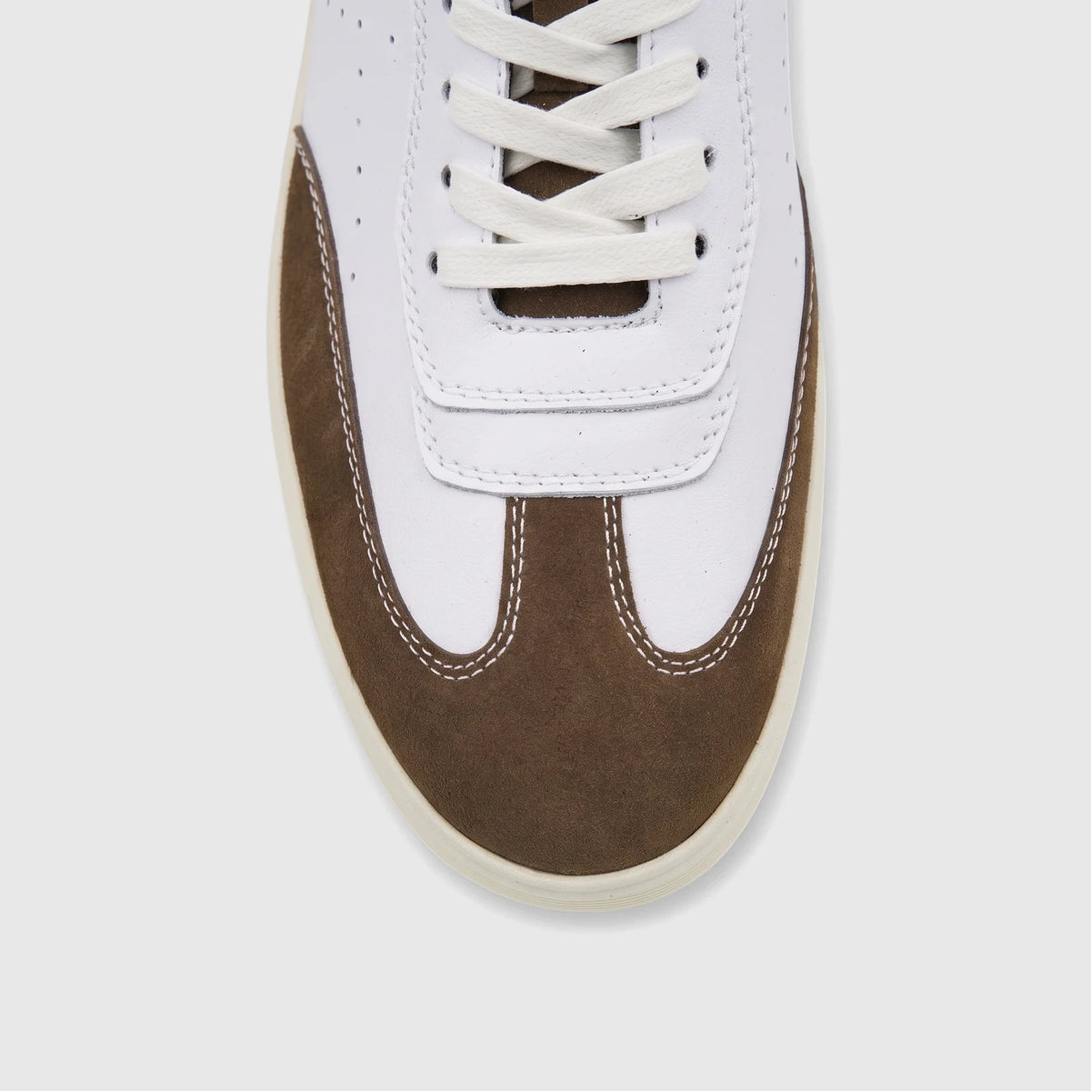 Close-up of a white and brown Crockett and Jones Men's Sneaker Roberto, featuring a white leather upper and brown suede toe
