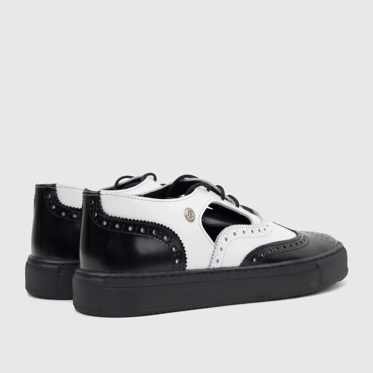 Crockett and Jones Men's Alonzo black and white leather lace-up brogue shoes with a thick black sole, side view.
