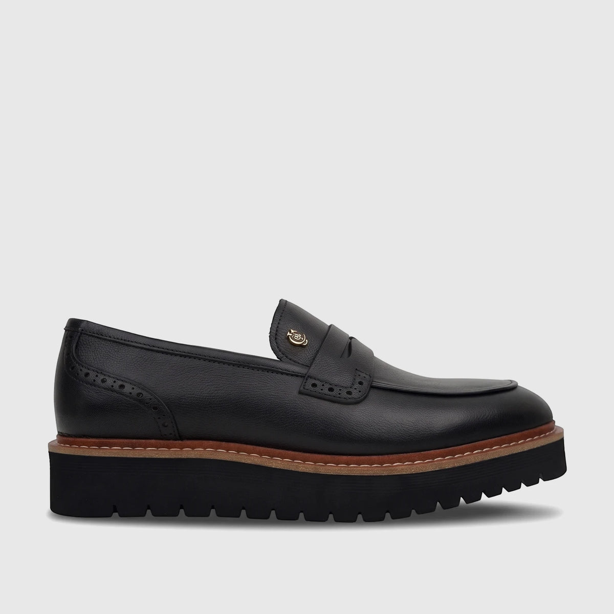 Men's black leather loafer with a chunky platform sole, perforated details, and gold-tone hardware, shown in a side profile.