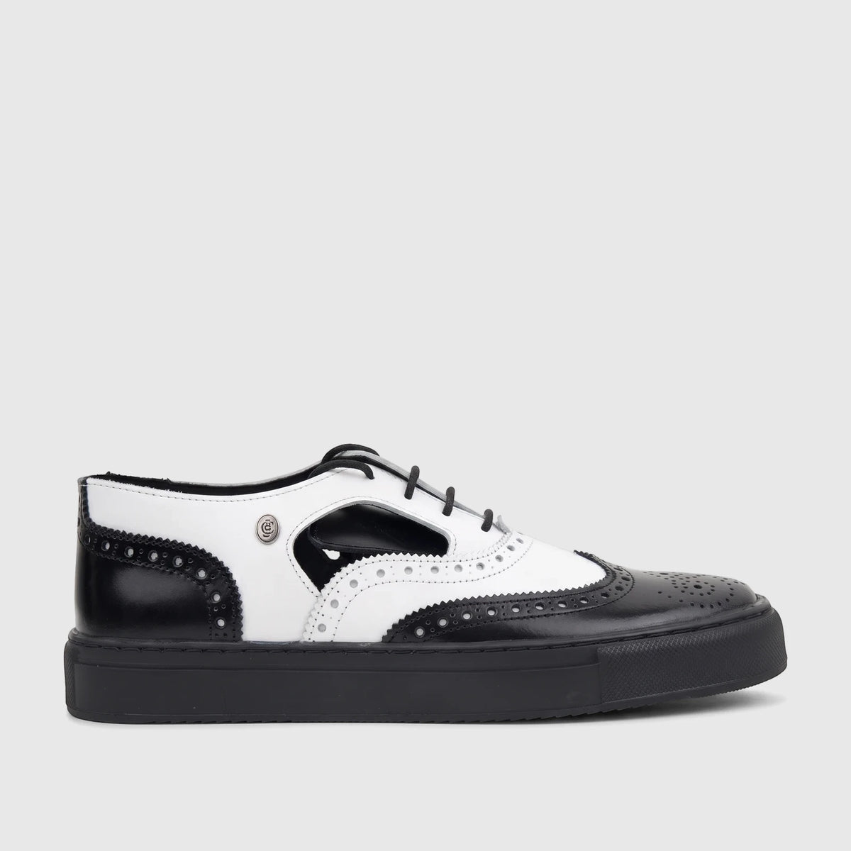 Crockett and Jones men's black and white lace-up brogue shoe with perforated details and a thick sole, side view.