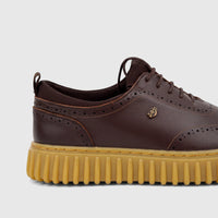 Crockett and Jones men's brown leather casual lace-up shoe with brogue detailing and a chunky yellow ridged sole, side view.