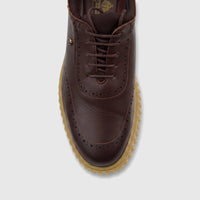 Top-down view of a Crockett and Jones men's brown leather chunky sole casual lace-up shoe with brogue details.