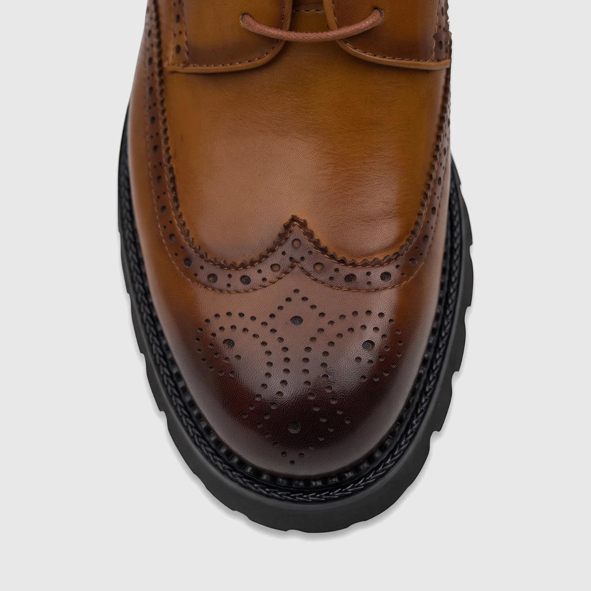 Close-up of Crockett And Jones Men's Chunky Sole Lace Up Brogue Santo shoe in brown leather with perforated details and a