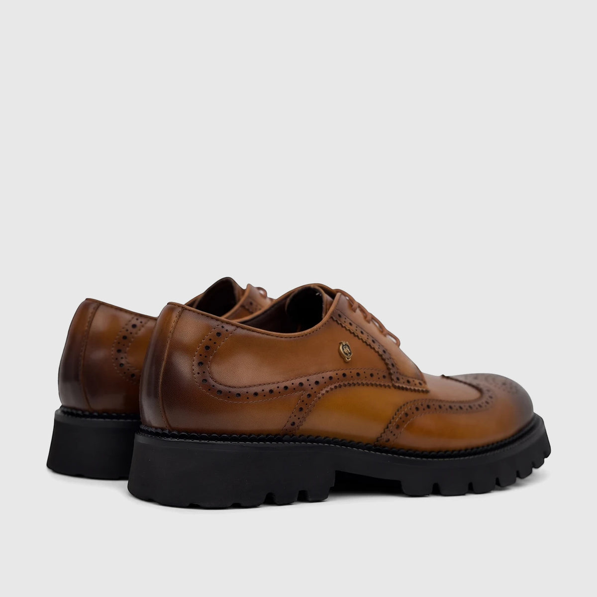 Crockett And Jones men's brown leather chunky sole lace-up brogue shoes with classic perforations, side-rear view.