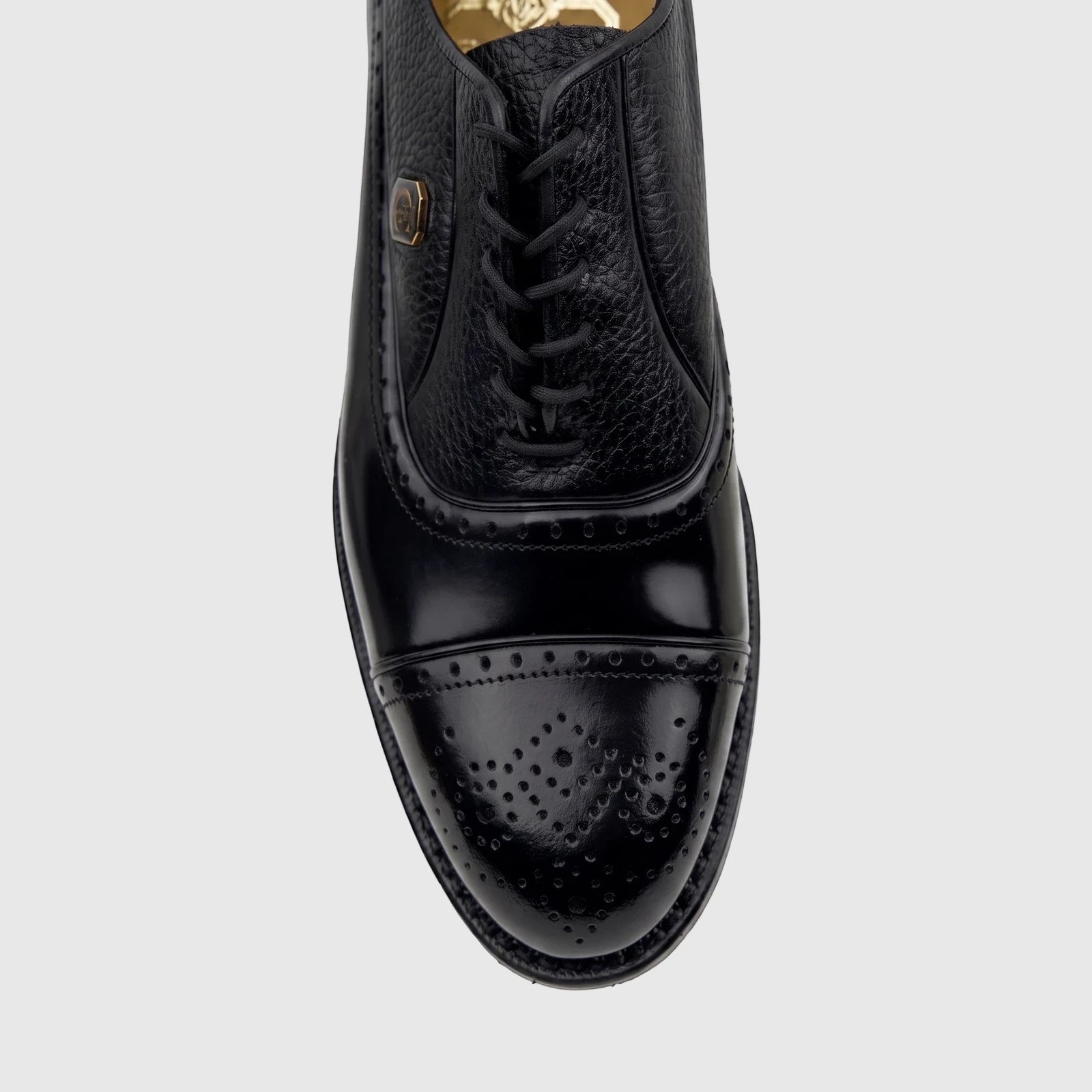 Close-up of a Crockett and Jones Men's Dress Lace Up Jason black leather oxford shoe with brogue details.