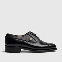 Black leather Crockett and Jones Men's Dress Lace Up Jason shoe, side view, with brogue detailing and a gold emblem.