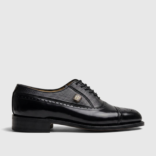 Black leather Crockett and Jones Men's Dress Lace Up Jason shoe, side view, with brogue detailing and a gold emblem.