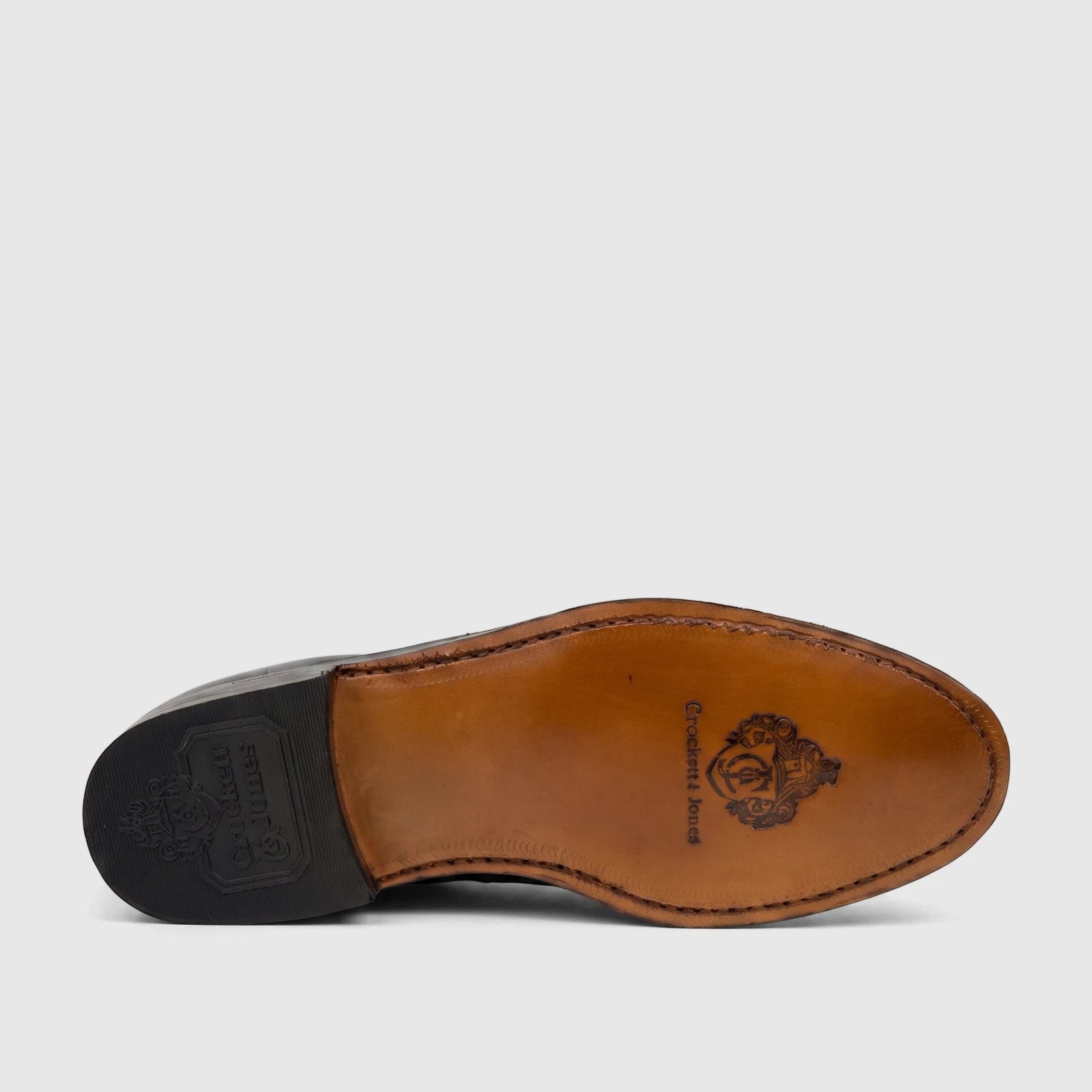 Sole view of a black Crockett & Jones Men's Jason dress lace-up shoe, featuring a brown leather sole and black heel with