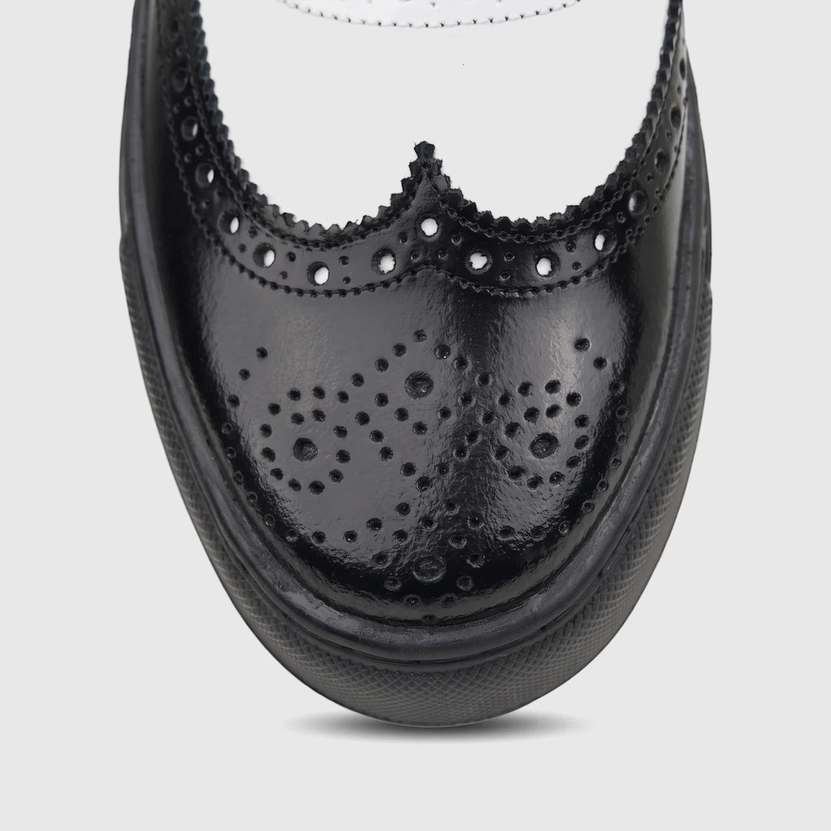 Close-up, top-down view of a Crockett and Jones Men's Lace Up Brogue Alonzo shoe in black and white leather with perforated
