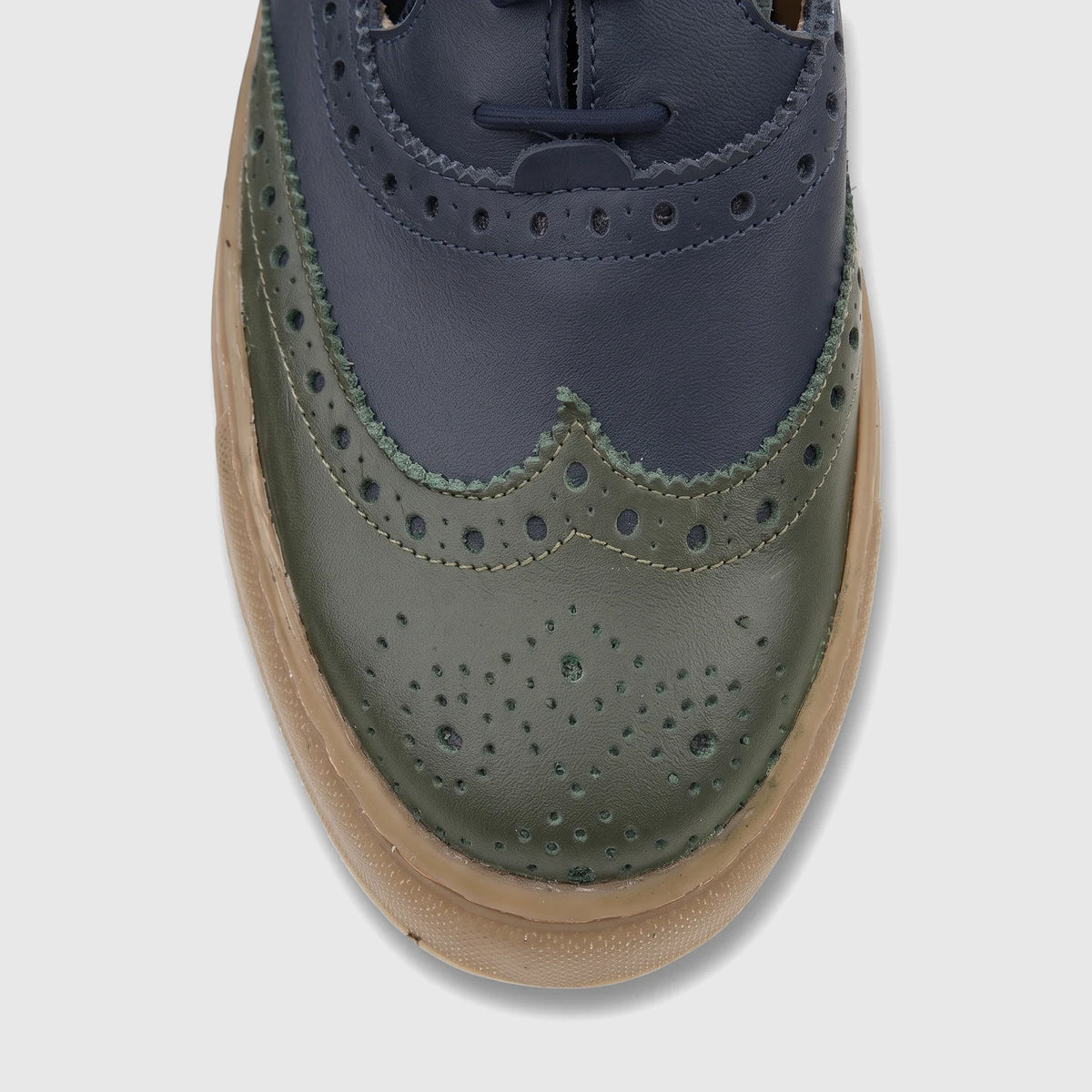 Close-up of a Crockett and Jones Men's Lace Up Brogue Alonzo shoe in navy and green leather, featuring classic brogue