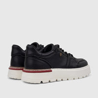 Pair of black leather Crockett and Jones Men's Tino sneakers with a white platform sole and red stripe detail.